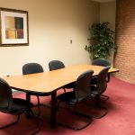 Board room with brick detailing and red carpet