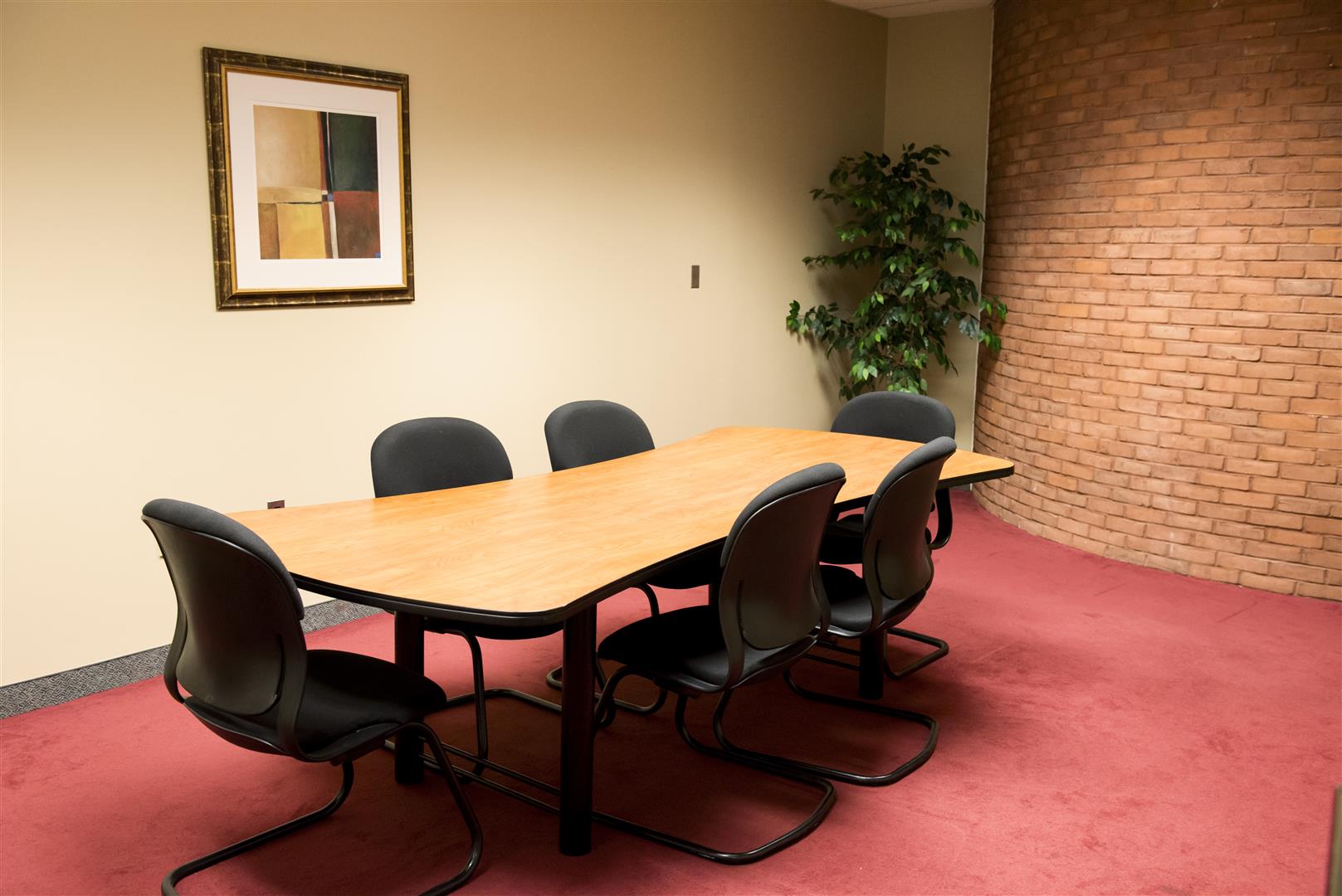 Board room with brick detailing and red carpet